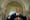 Mayor Eric Adams smiling behind a lectern in New York City Hall