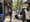 A person walking on a NYC sidewalk with what appears to be a takeout bag of lunch