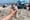 A person holding a nutcracker up with a view of the beach and ocean in the background.