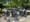 A group of cyclists bike through concrete bollards on the crowded Hudson River Greenway.