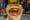 A person holds a fresh cheeseburger up to the camera.