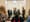 Men in ill-fitting suits stand around preventing housing activists from disrupting proceedings on the Senate site.