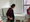 A prospective tenant assesses a bathtub in the kitchen of a studio apartment.