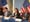 Eric Adams and staff sit at a table at City Hall during a press conference