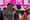 Eric Adams wearing a big grey sweater standing next to Winnie Greco in Times Square.