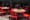 A group of red chairs sitting around a wooden table at a restaurant in New York City.
