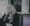 Lucy Sante sits on a porch.
