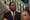 A photo of Timothy Pearson standing behind Eric Adams at City Hall.